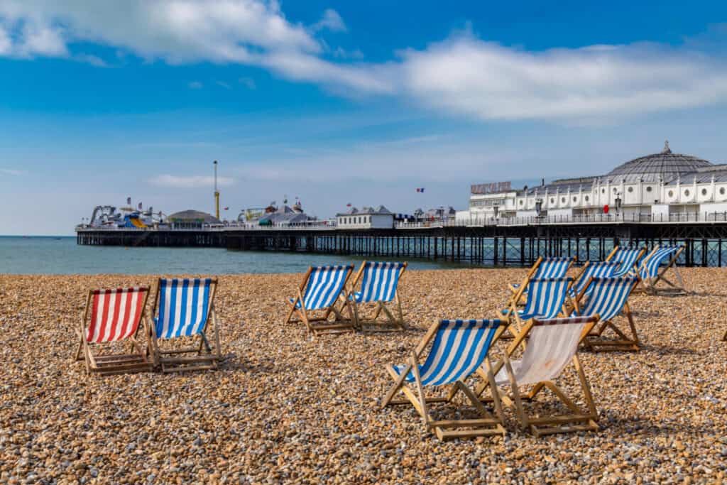 Deck chairs on Brighton Beach in front of Palace Pier
