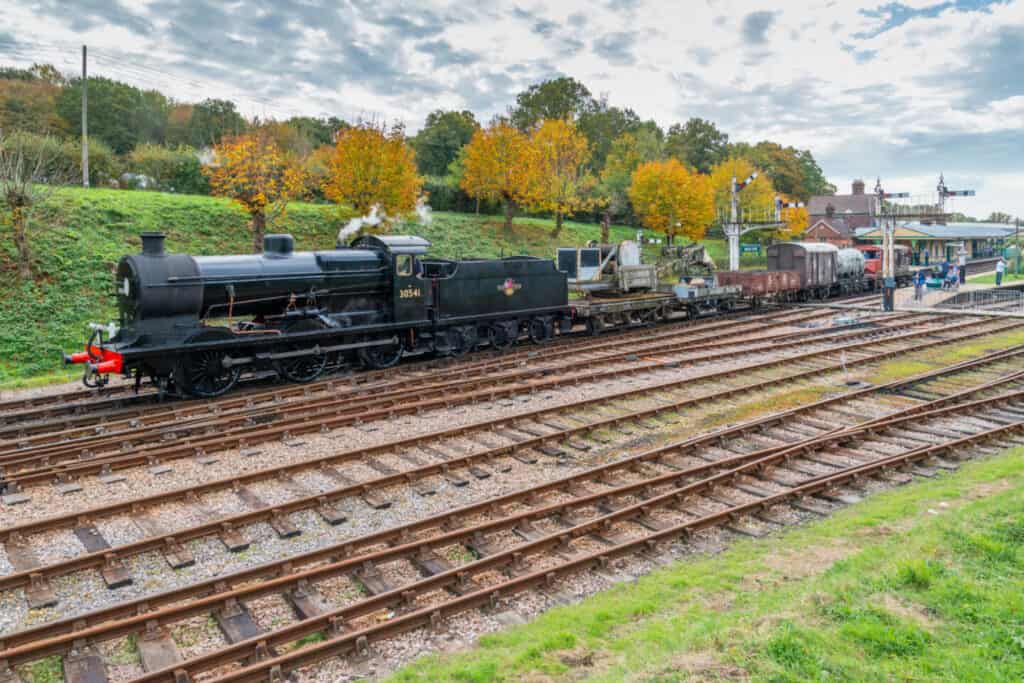 Steam train pulling haulage on the Bluebell Railway - one of the many days out with kids in Sussex