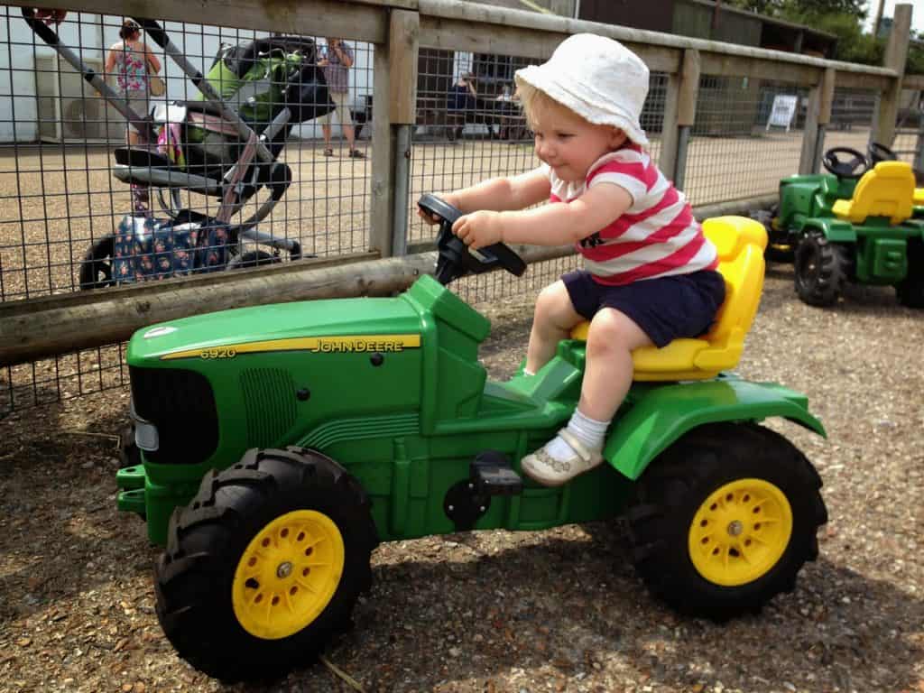 Tot on toy tractor at Longdown Activity Farm in the New Forest