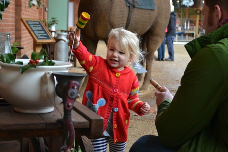 Tin Box Tot playing with a cup and ball at Mottisfont Abbey