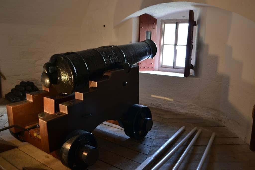 A cannon pointing out of a window at Dartmouth Castle