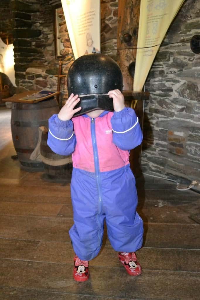 Tin Box Tot wearing a helmet at Dartmouth Castle