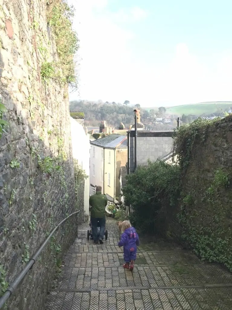 Mr Tin Box and Tot walking down a footpath in Dartmouth at New Year
