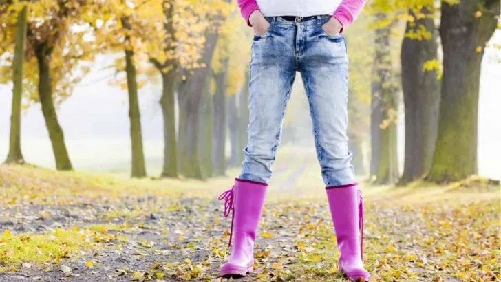 Woman in wellies in autumn lane
