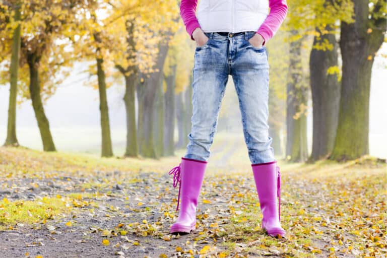 Woman in wellies in autumn lane