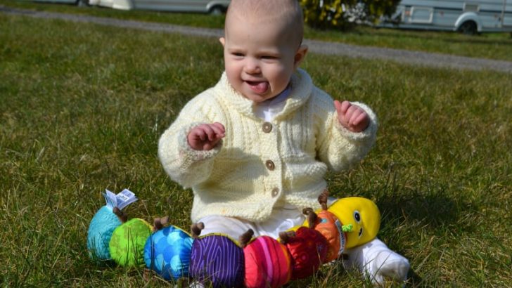 Tin Box Baby playing during our North Devon caravan weekend - caravanning with a baby