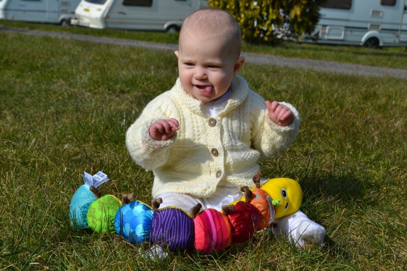 Tin Box Baby playing during our North Devon caravan weekend - caravanning with a baby