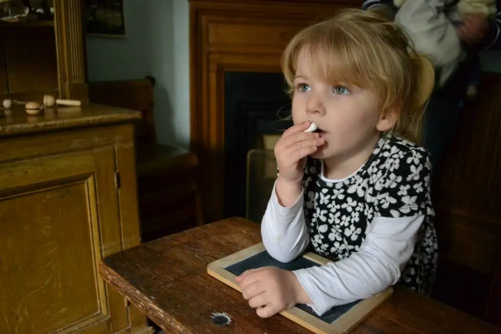 Tin Box Tot in the school room - Exploring Victorian life at Lanhydrock National Trust