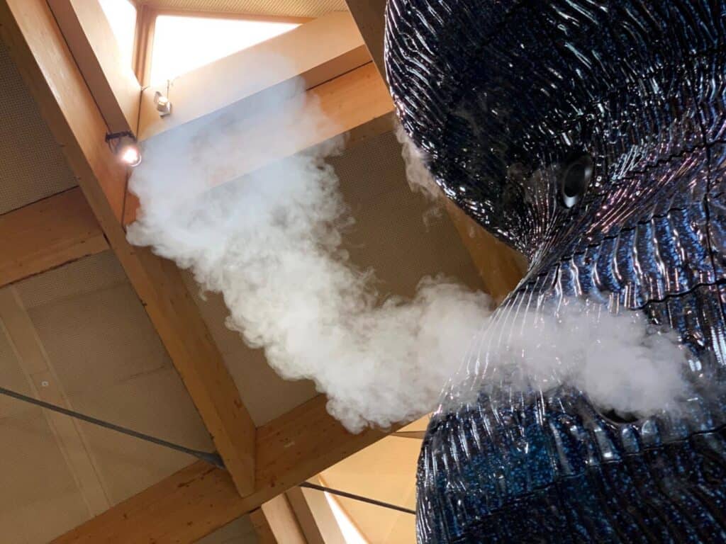Smoke coming out of The Blue art installation at The Eden Project