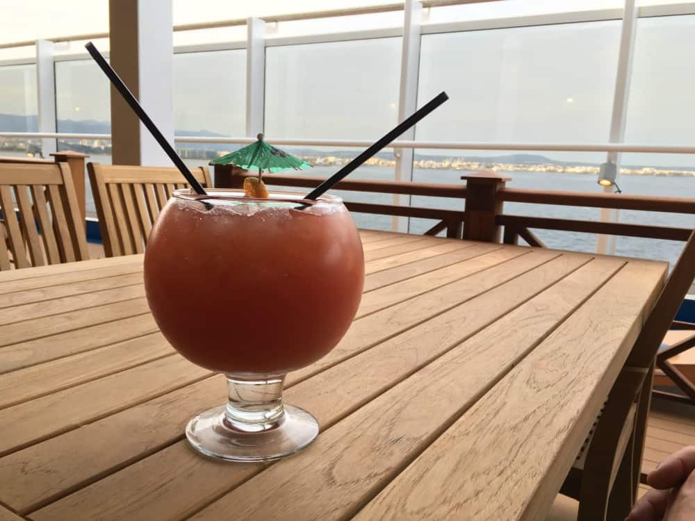 Cocktail on wooden table overlooking the sea