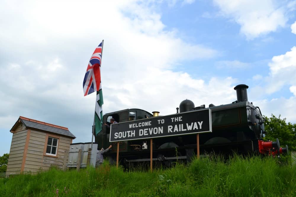 Steam train family fun on South Devon Railway : steam train by station sign