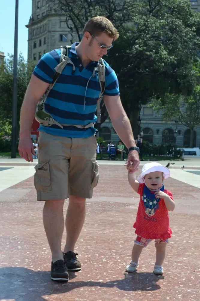 Tin Box Baby walking in Placa Catalonia - Barcelona with a buggy