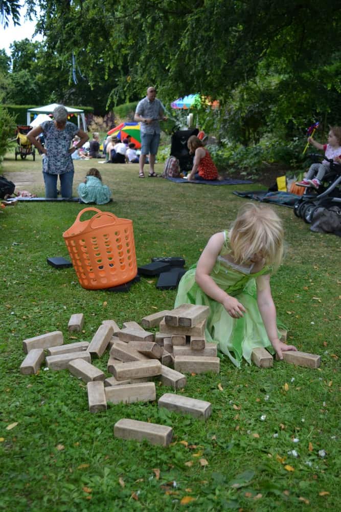 Tin Box Tot playing game of Jenga at Midsummer Dreams Festival at Darlington Hall