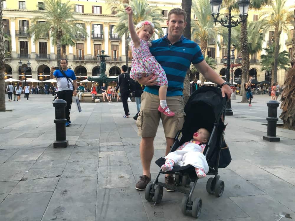 Tin Box family in Placa de Relat - Barcelona with a buggy