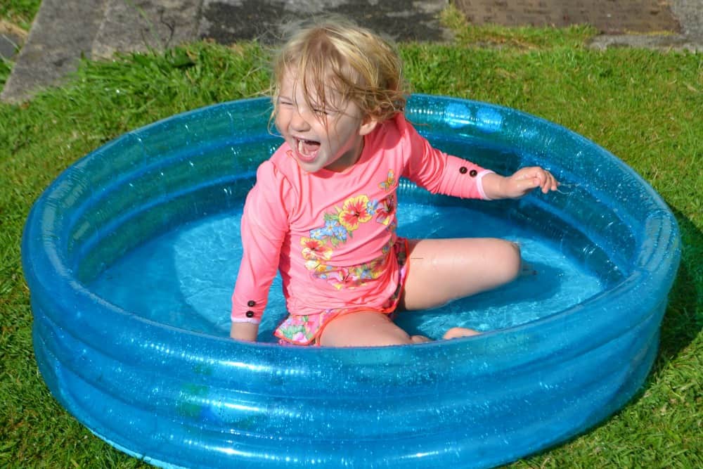 Tin Box Tot sat in paddling pool - Big Little Tent Festival