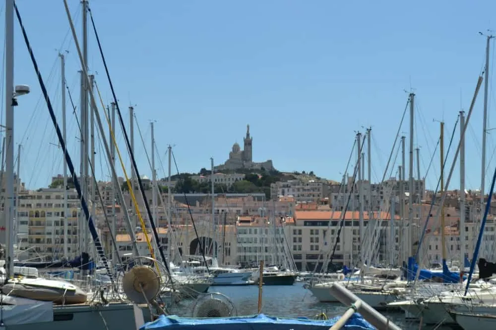 Old Port in Marseilles and a view up to the Basilica - Le Petit Train Marseille
