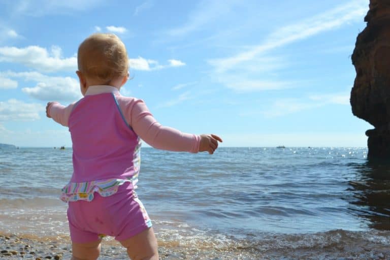 Tin Box Baby pointing out to sea