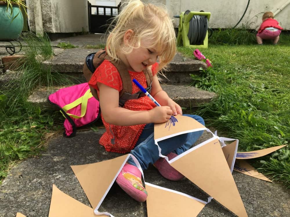 Tin Box Tot decorating bunting with a pen - Big Little Tent Festival