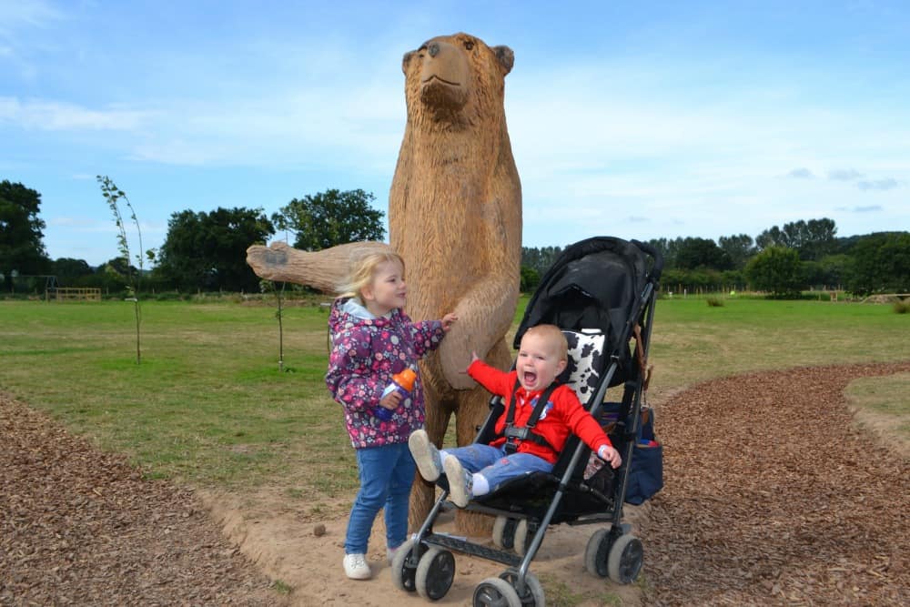 Tin Box girls and wooden bear at The Bear Trail in Devon