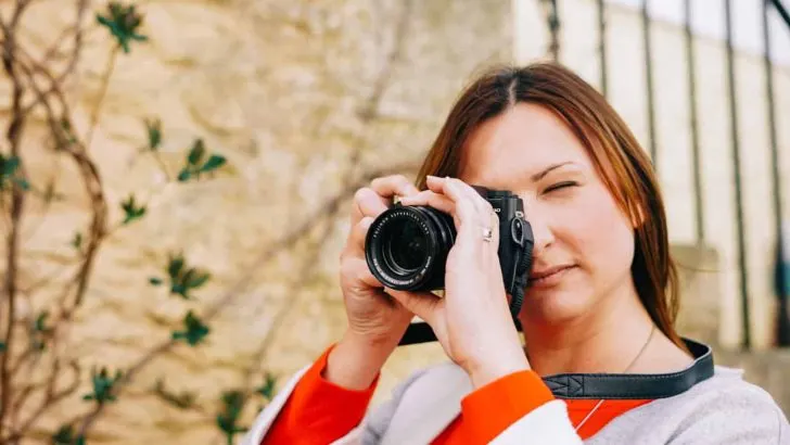 Claire holding camera to face to take picture