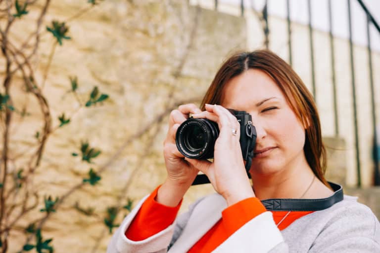 Claire holding camera to face to take picture