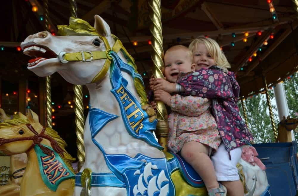 Tin Box girls on a carousel horse - glamping at Crealy Meadows in Devon