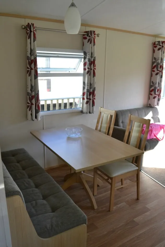 Dining area in three bedroom pet friendly caravan at Trevella Holiday Park