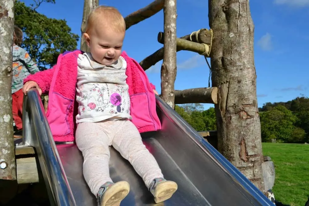 Tin Box Tot on the East Lawn playground at The Lost Gardens of Heligan - Heligan with children