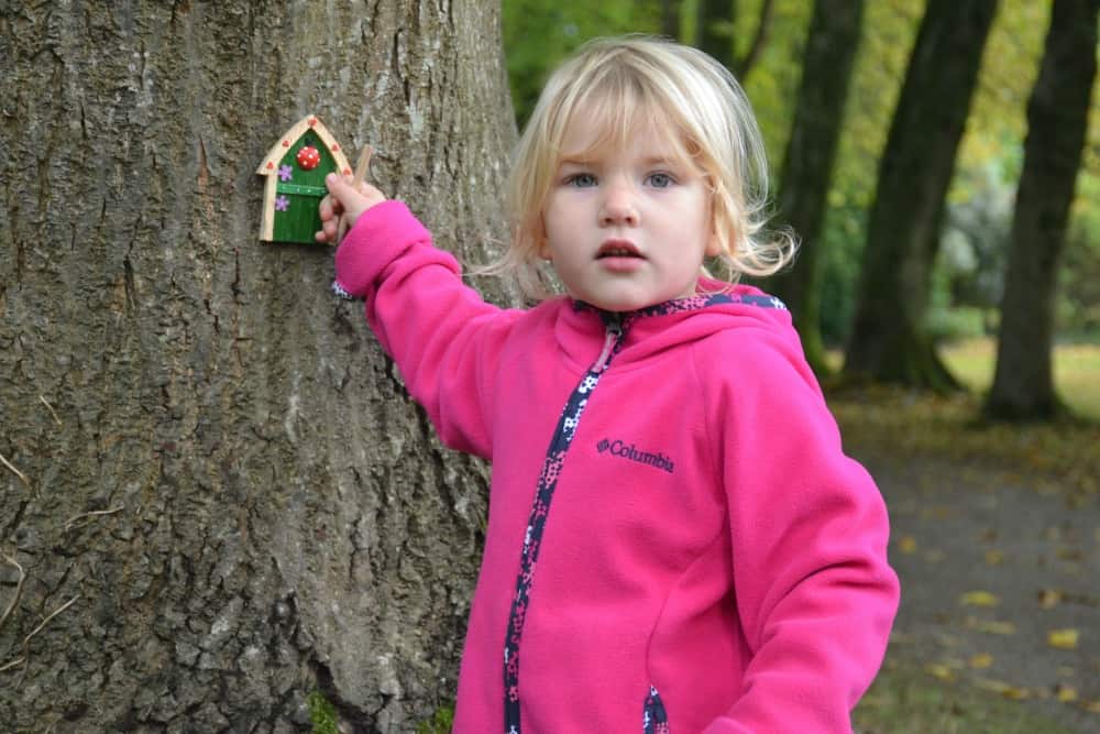 Tin Box Tot knocking on a fairy door - outdoor children's activities at Saltram National Trust in Devon