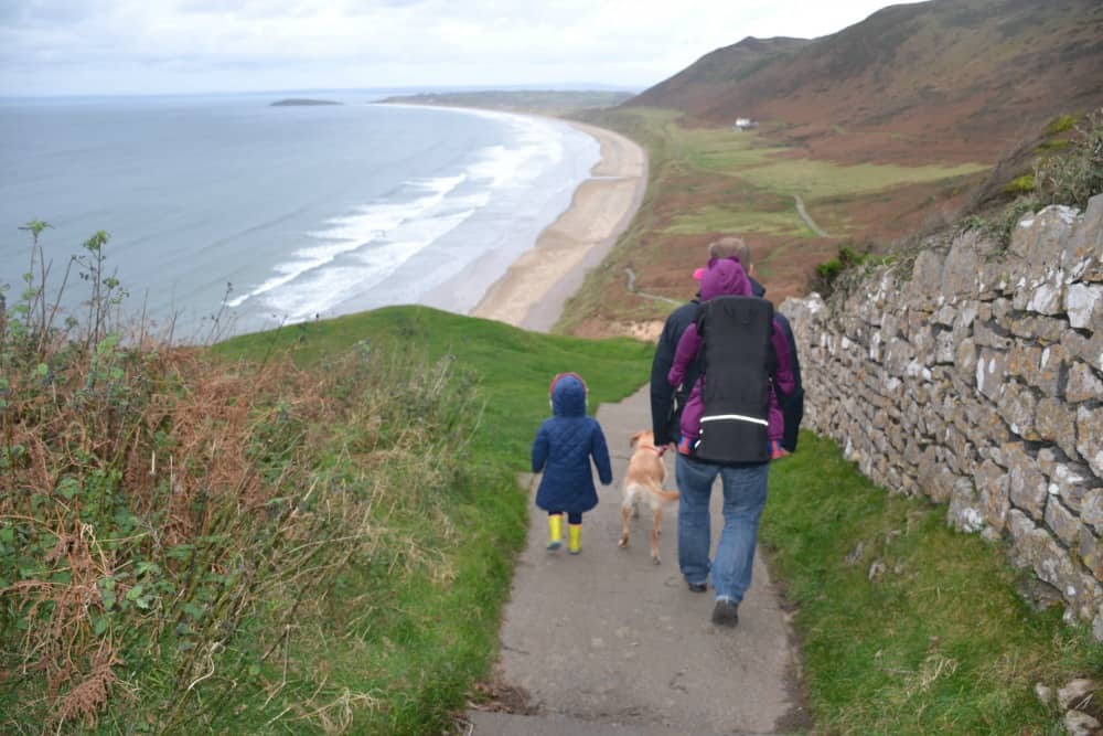 Tin Box family walking down to Rhossili Bay - 5 awesome Gower beaches for families