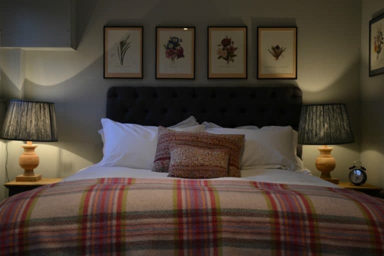 Bed in the Wentworth Room at Bedside table at Bel & The Dragon Churt