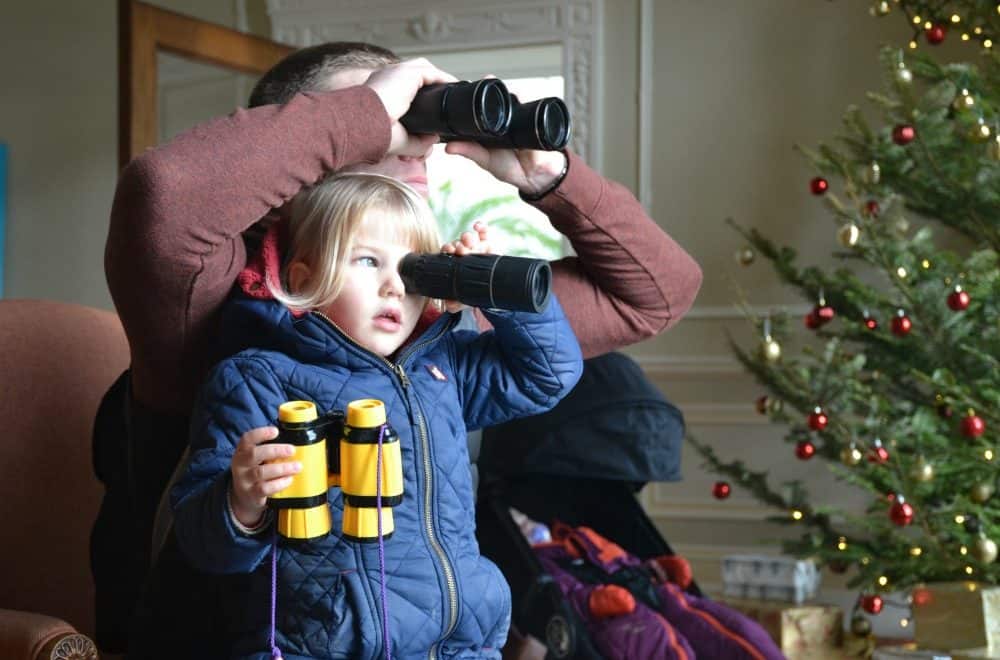 Looking through binoculars at Trelissick National Trust