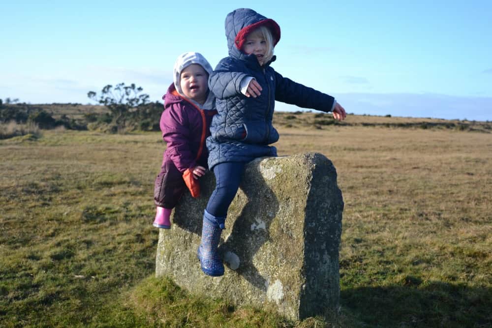 Tin Box Tot and Baby playing on stone - Stunning walks on Bodmin Moor for active families