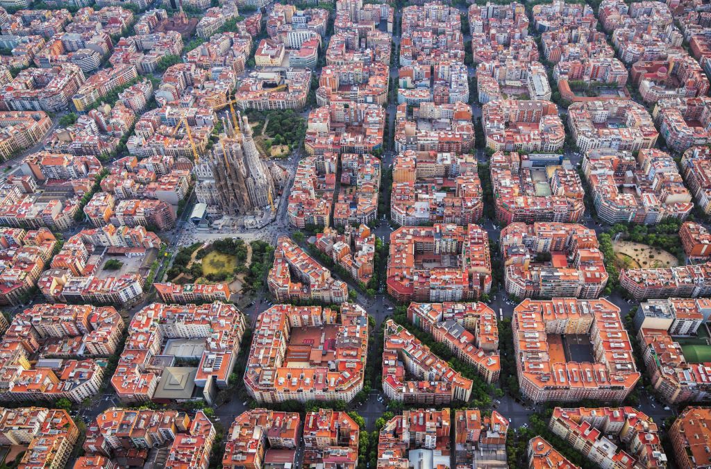 Aerial view of Barcelona Eixample residencial district and Sagrada familia, Spain. Late afternoon light