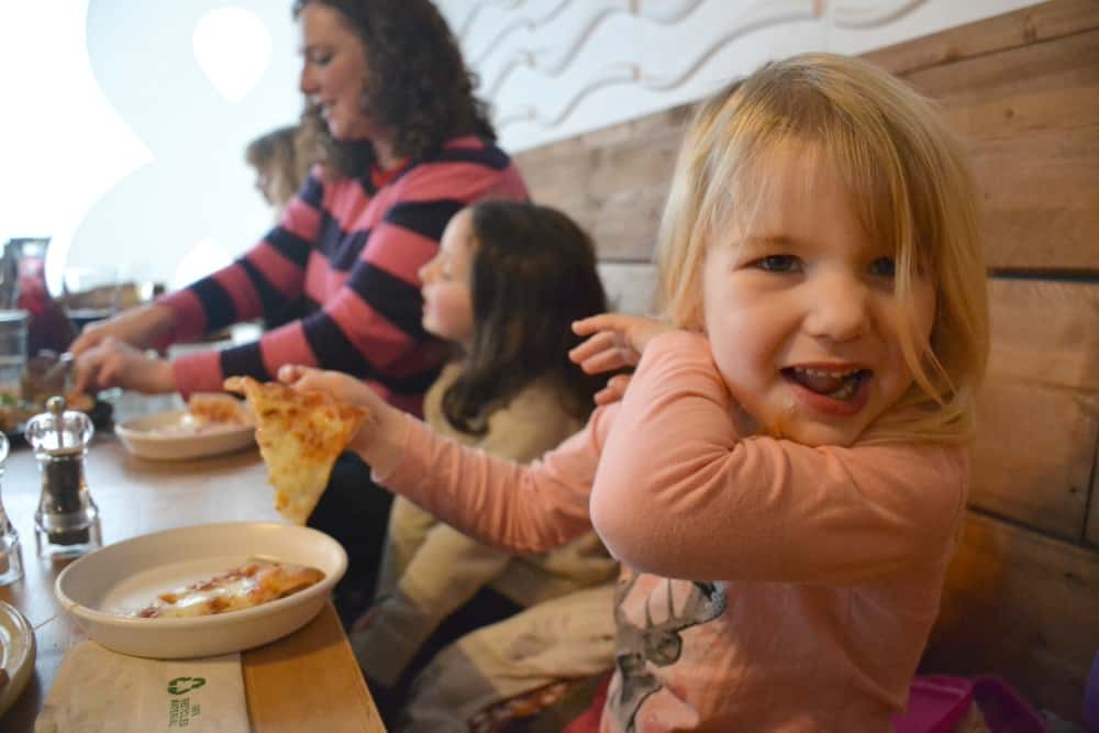 Tin Box Tot eating pizza at ODE&Co at Coast View Holiday Park