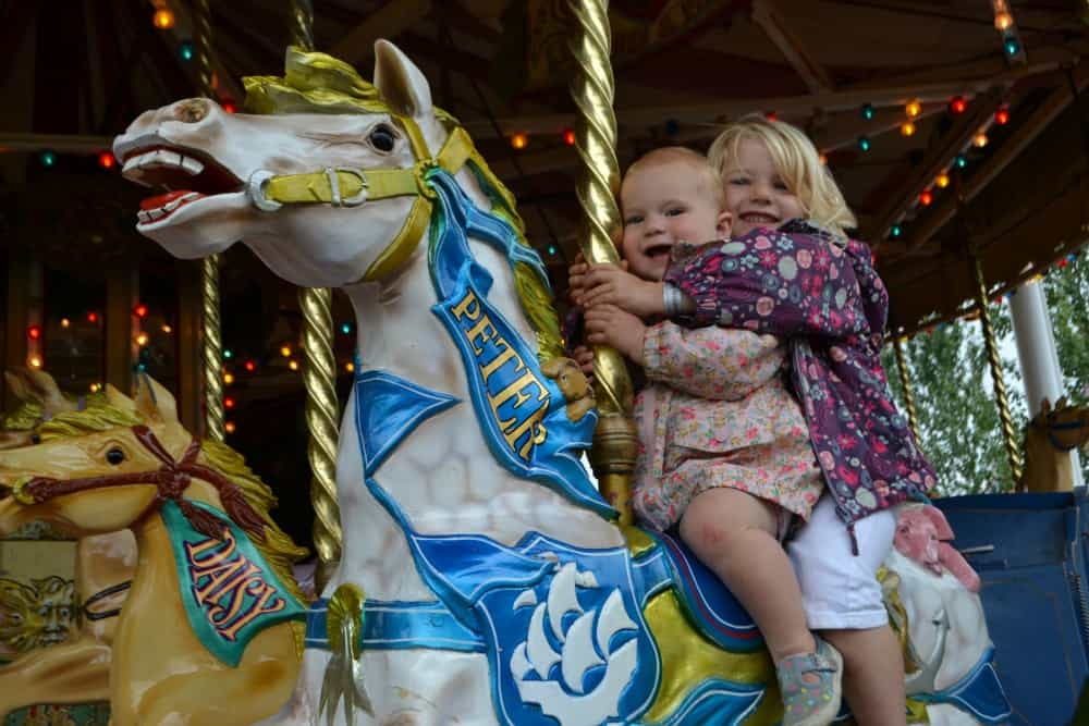 Tin Box girls on carousel - 7 reasons why families love Crealy Great Adventure Park