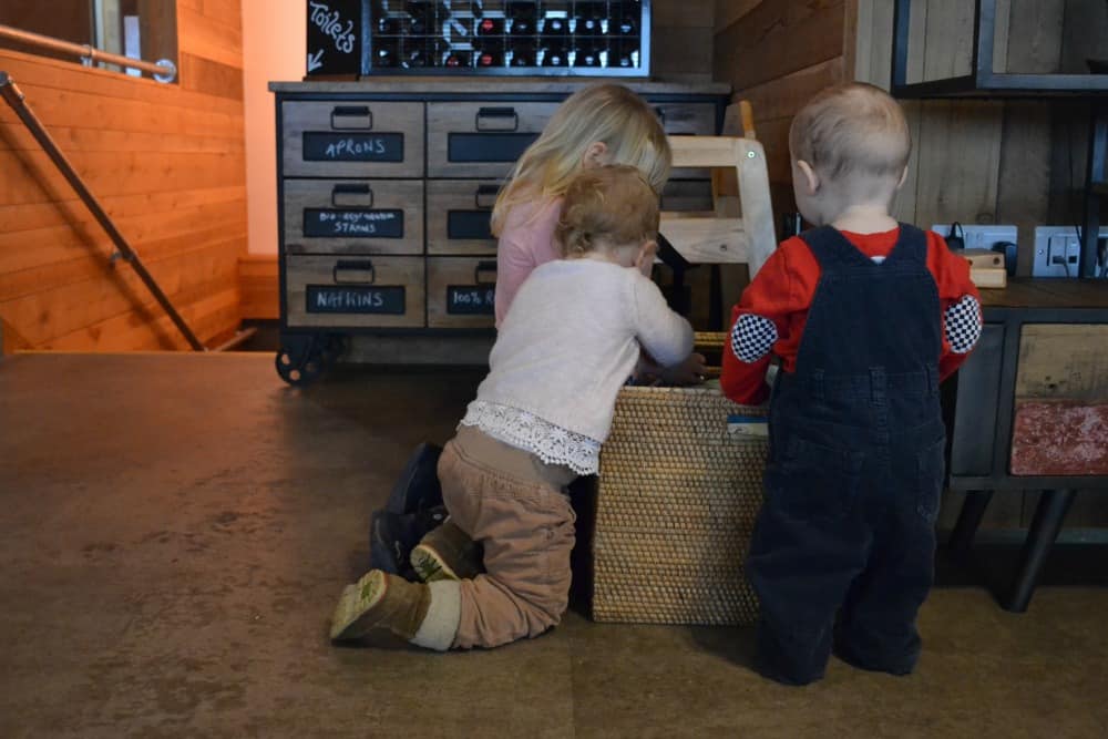 Tin Box girls and friend searching through toy box at ODE&Co at Coast View Holiday Park