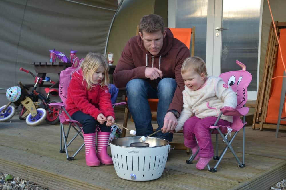 Toasting marshmallows on a Lotus Grill - an essential for glamping with kids