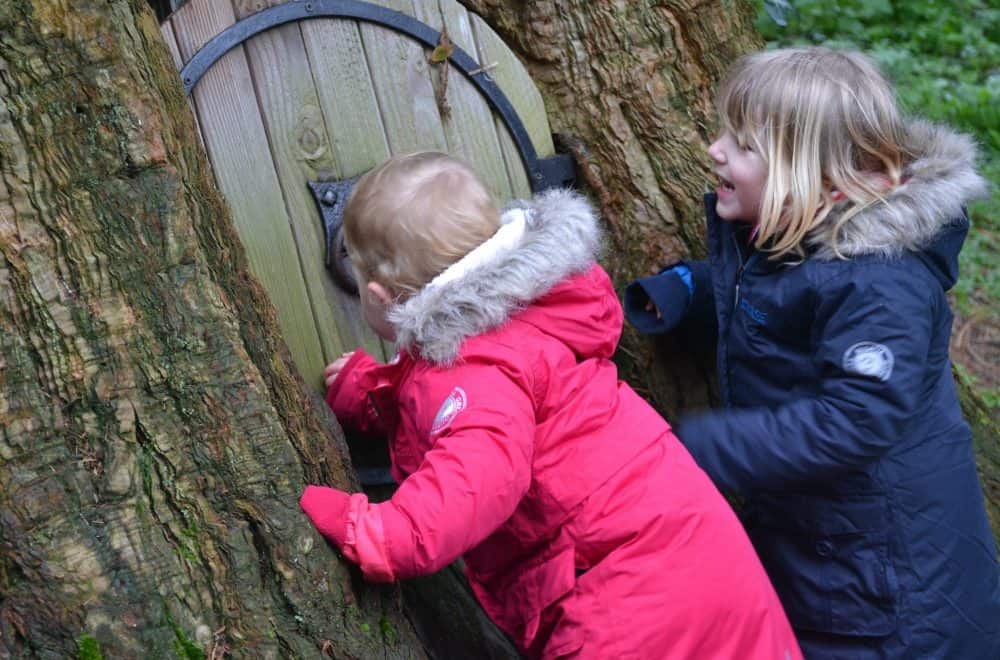 Tin Box girls knocking on a fairy door at Wildwood Escot a Devon day out