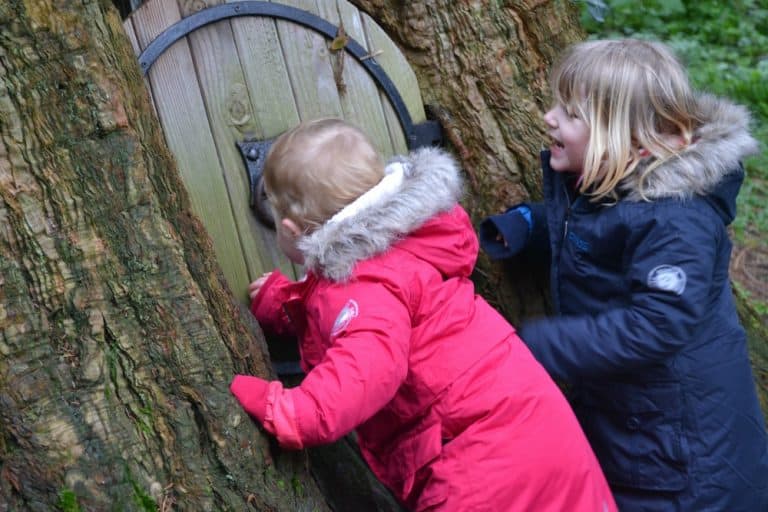 Tin Box girls knocking on a fairy door at Wildwood Escot a Devon day out