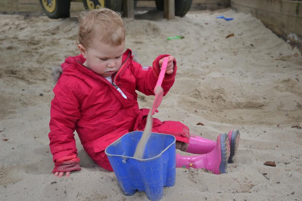 Tin Box Baby playing with sand at The Big Dig at Woodlands: Easter in Devon