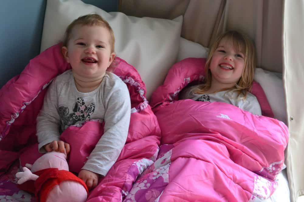 Tin Box girls in Trespass sleeping bags - essential packing list: glamping with kids