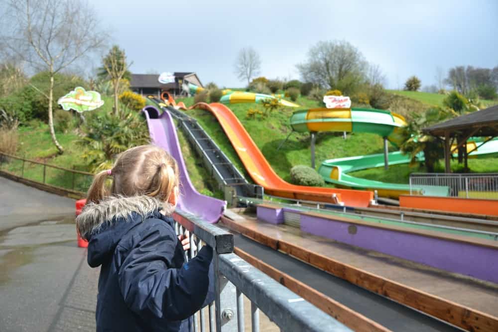 Tin Box Tot looking at watercoasters at Woodlands: Easter in Devon