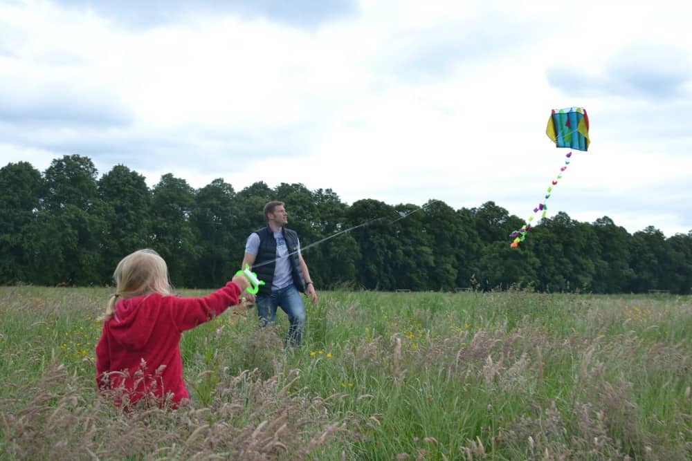 Tin Box Tot flying a kite in fields at Hardwick Hall Derbyshire