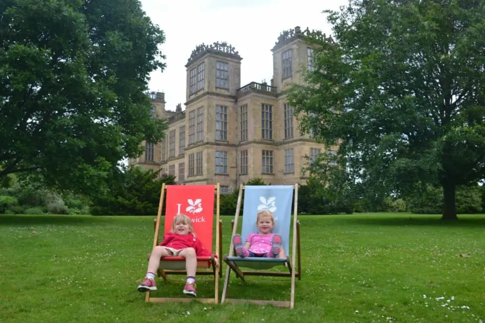 Tin Box girls sat in deckchairs front of Hardwick Hall