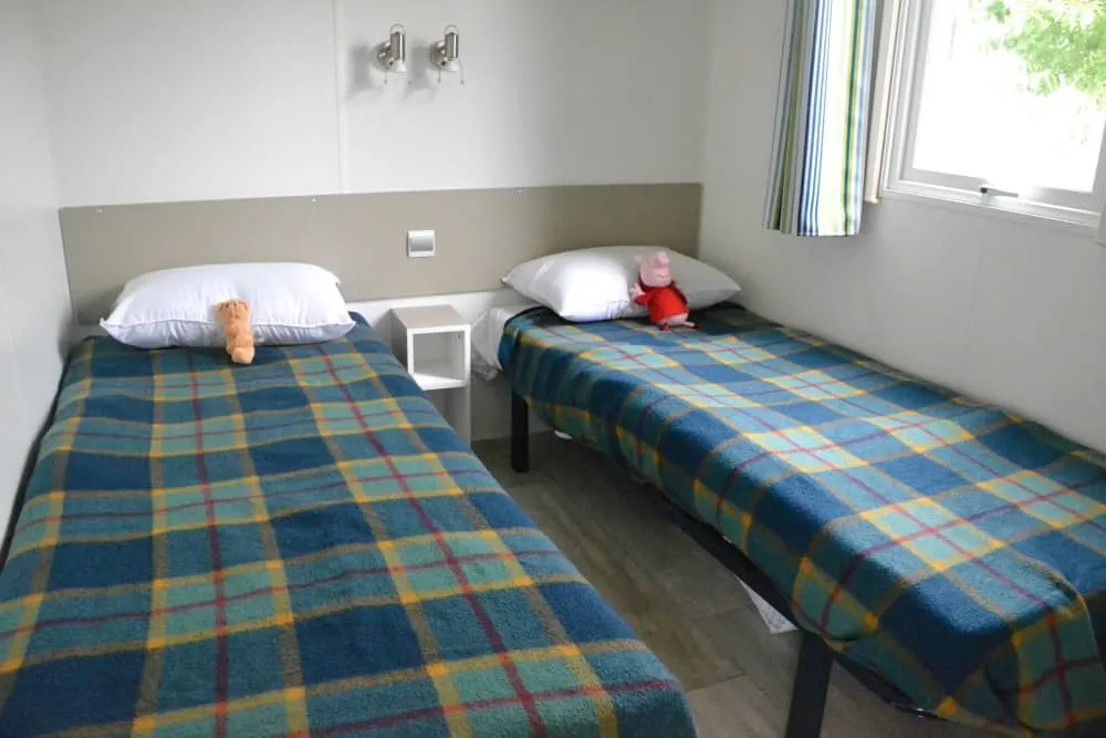 Twin bedroom in caravan at Pin Parasol - Tin Box Tot on seesaw at Pin Parasol - caravan holiday in France, Al Fresco Holidays