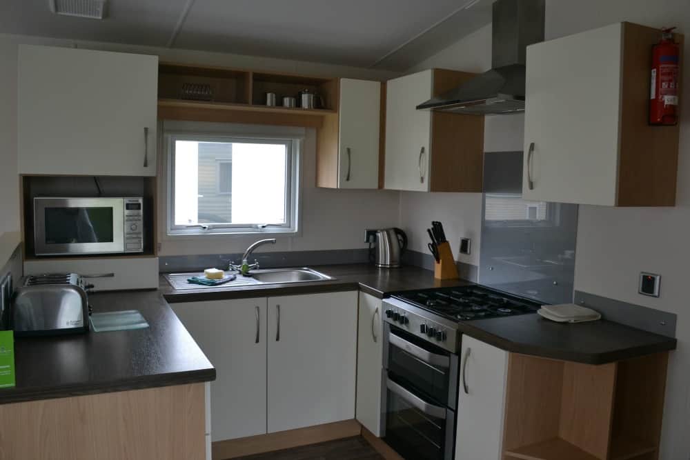 Kitchen in a Tin Box Baby at the front window of a Gwithian 3 Bedroom - Premium caravan at Hendra Holiday Park