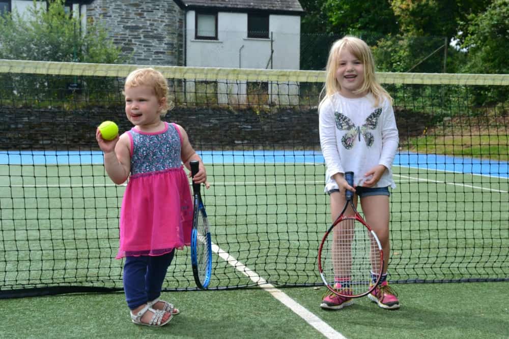 Tin Box girls on tennis court at China Fleet Country Club where we had a spa break with kids