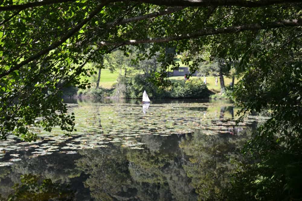 Model boat on lake at Canonteign Falls - England's highest manmade waterfall