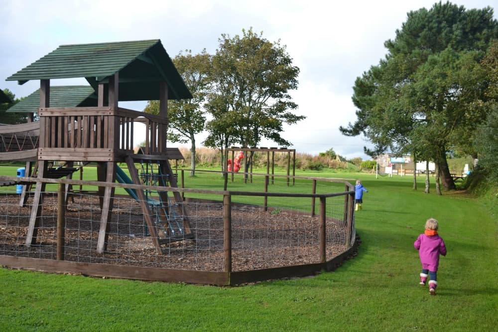Girls running past playground at Seaview International review a family campsite in Cornwall